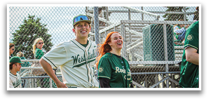 A man and a woman walking on a baseball field. Description generated by AI