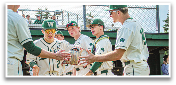 A group of baseball players on a field. Description generated by AI