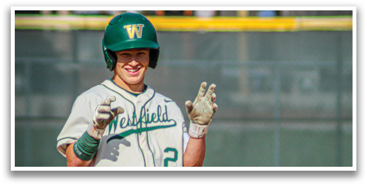A baseball player wearing a green helmet and a white jersey with the number 2 on it. Description generated by AI