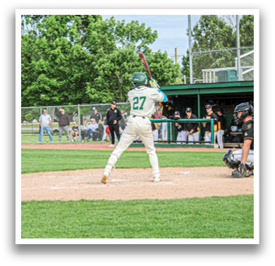 A baseball player is swinging a bat on a field. Description generated by AI