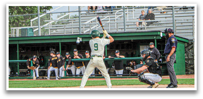 A baseball player is holding a bat and getting ready to hit the ball. Description generated by AI