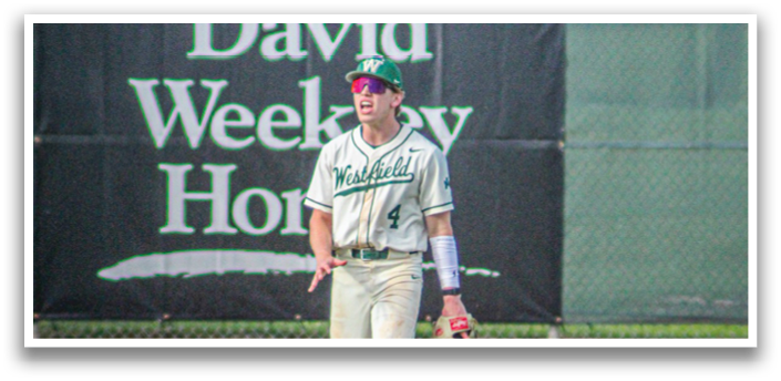 A baseball player in a white uniform with a green cap and a white glove. Description generated by AI