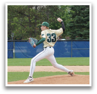 A baseball player in a green and white uniform is standing on the field. Description generated by AI