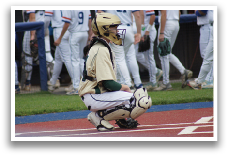 A baseball player in a green shirt and white pants is pitching a ball. Description generated by AI