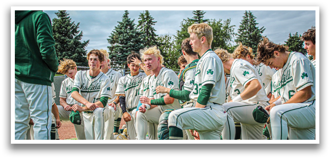 A group of baseball players sitting on the grass. Description generated by AI