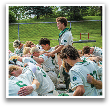 A group of baseball players huddled together on the field. Description generated by AI