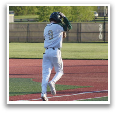 A baseball player wearing a white uniform and a green helmet. Description generated by AI