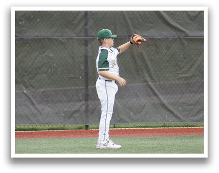 A baseball player wearing a green and white uniform is standing on the field. Description generated by AI