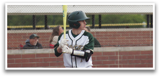 A baseball player holding a bat. Description generated by AI