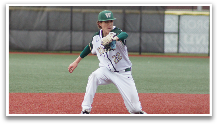 A baseball player is in the middle of a game, wearing a green and white uniform. Description generated by AI