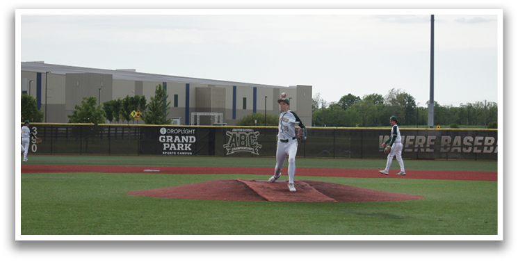A baseball player is standing on the pitcher's mound. Description generated by AI