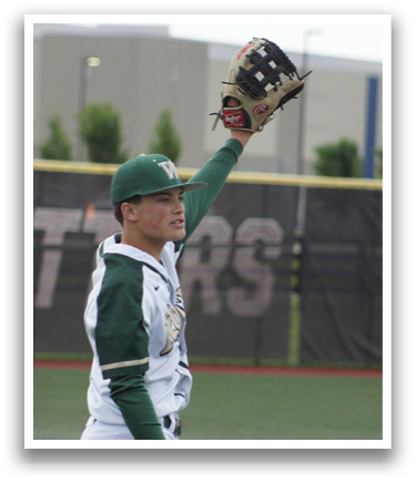A baseball player wearing a green and white uniform is holding a catcher's mitt. Description generated by AI