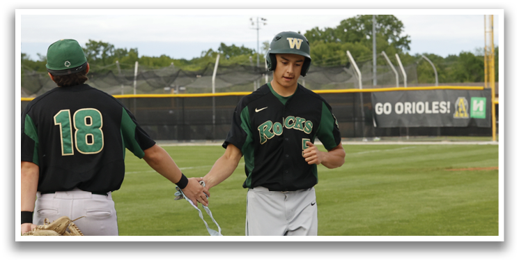 Two baseball players walking on a field. Description generated by AI