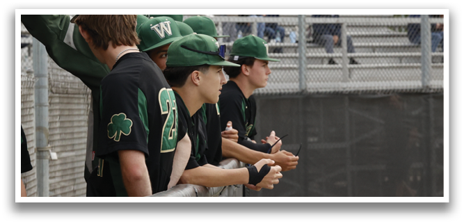 A group of baseball players wearing green and white uniforms. Description generated by AI