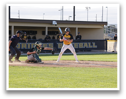 A baseball player is swinging a bat at a ball. Description generated by AI