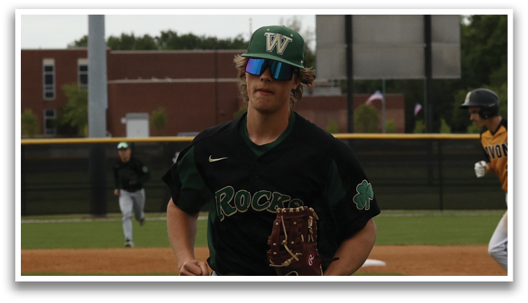 A baseball player wearing a black shirt and sunglasses. Description generated by AI