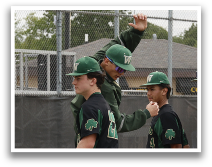 A group of baseball players wearing green and black uniforms. Description generated by AI