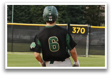 A baseball player wearing a black and green jersey with the number 6 on it. Description generated by AI