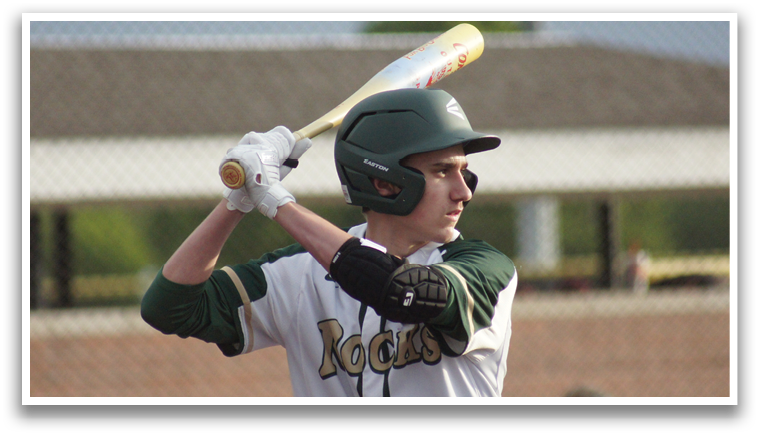 A baseball player is holding a bat and preparing to swing. Description generated by AI