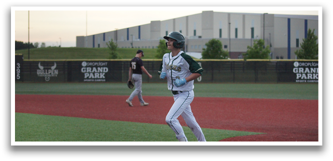 A baseball player wearing a white uniform is running on the field. Description generated by AI