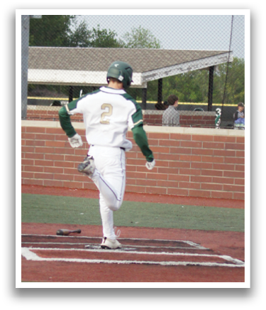 A baseball player is holding a bat, ready to swing. Description generated by AI
