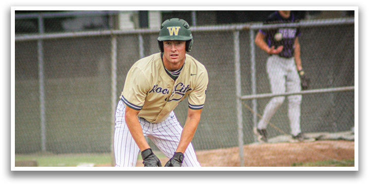 A baseball player wearing a green helmet and a gold and white uniform. Description generated by AI