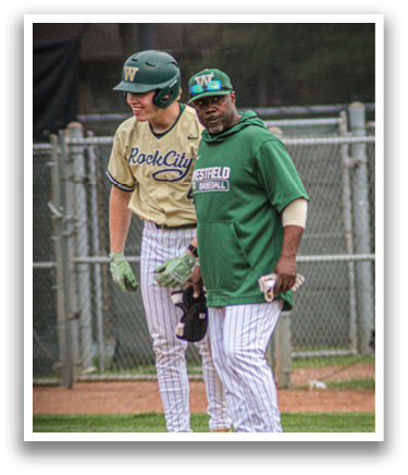Two men wearing green and white baseball uniforms. Description generated by AI