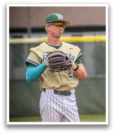 A baseball player wearing a green and white uniform and holding a baseball glove. Description generated by AI