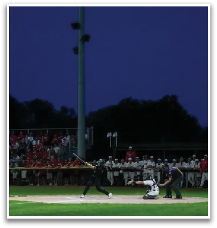A baseball player wearing a green and white uniform. Description generated by AI