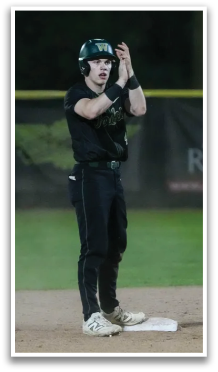 A baseball player wearing a yellow and green jersey. Description generated by AI