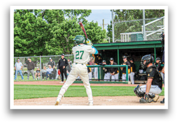 A baseball player is swinging a bat on a field. Description generated by AI