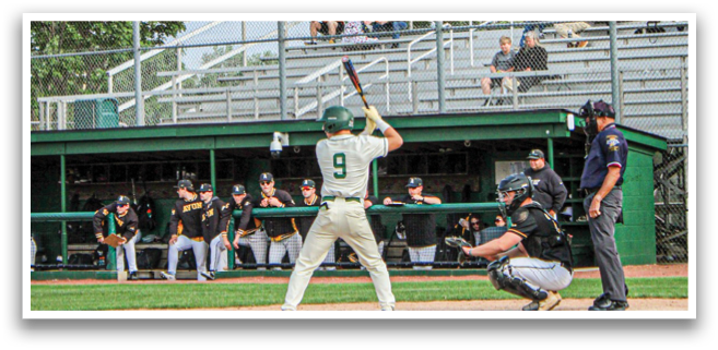 A baseball player is holding a bat and getting ready to hit the ball. Description generated by AI
