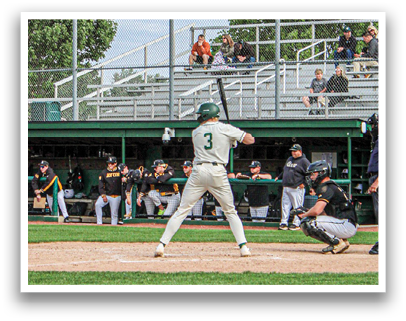 A baseball player is swinging a bat on a field. Description generated by AI