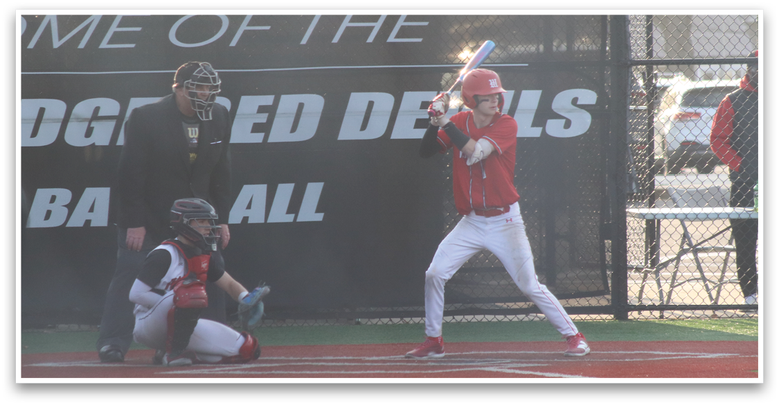A baseball player is at bat, holding a bat and preparing to swing. AI generated content