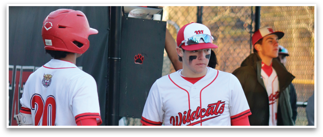 A baseball player wearing a red and white uniform. Description generated by AI