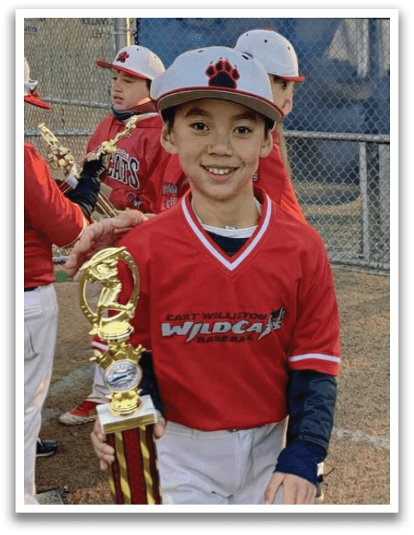 A young boy holding a trophy. Description generated by AI