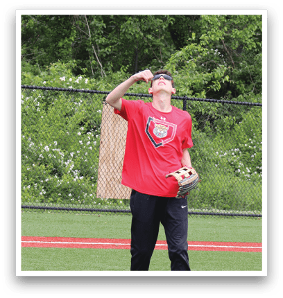 A man in a red shirt and black pants is holding a tennis racket and preparing to hit a tennis ball. Description generated by AI