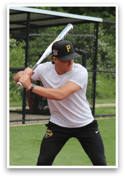 A man in a white shirt and black hat is swinging a baseball bat. Description generated by AI