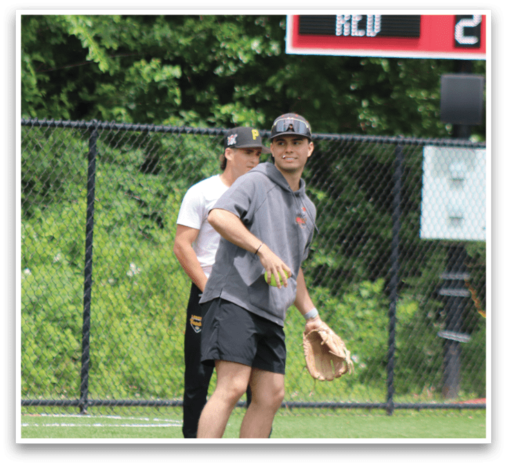 A baseball player wearing a black shirt and black shorts. Description generated by AI