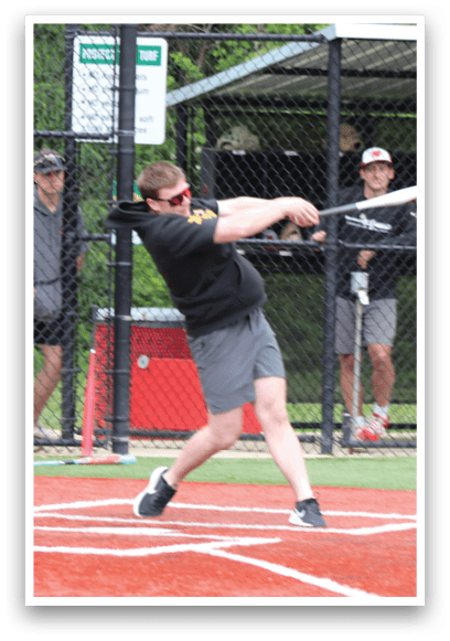 A baseball player is swinging a bat at a ball. Description generated by AI