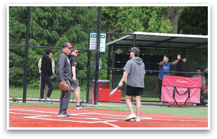 A baseball player holding a bat. Description generated by AI
