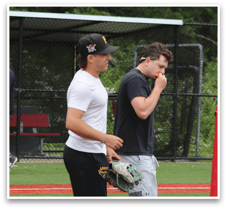 A baseball player wearing a white shirt and black shorts. Description generated by AI