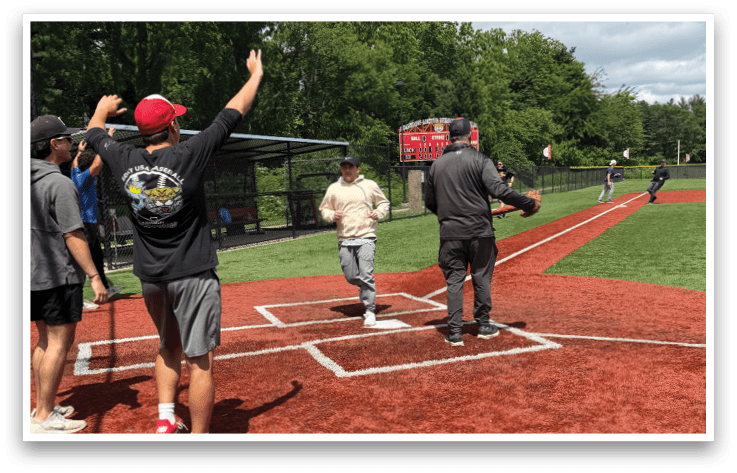 A baseball field with a man standing on home plate. Description generated by AI