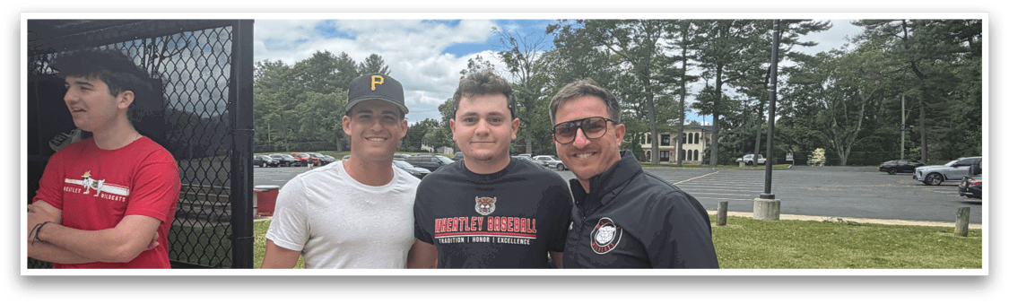 Three men standing in front of a fence. Description generated by AI