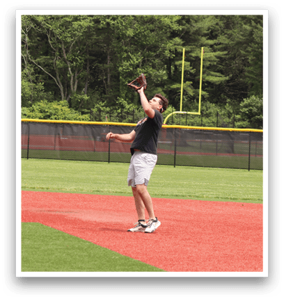A man catching a ball in a baseball field. Description generated by AI