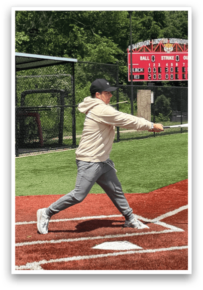 A baseball player is swinging a bat at a ball. Description generated by AI