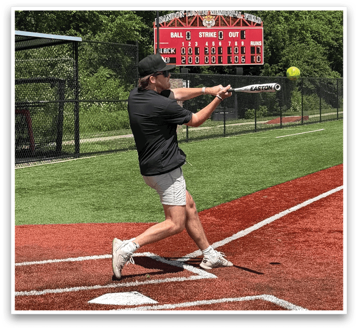 A man is swinging a bat at a ball. Description generated by AI