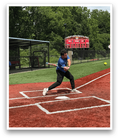 A baseball player is swinging a bat at a ball. Description generated by AI