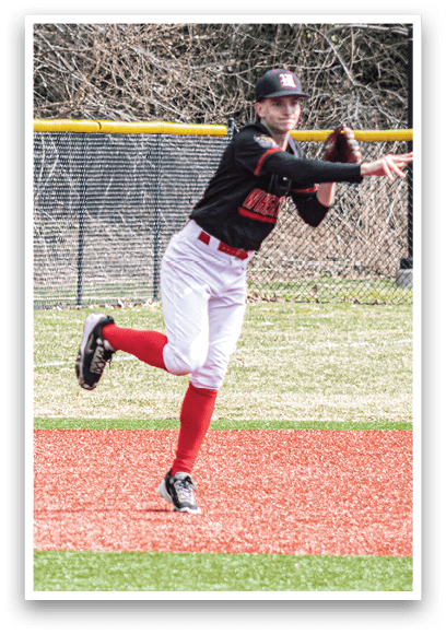 A baseball player in a black and white uniform is throwing a ball. Description generated by AI