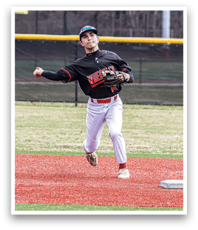 A baseball player in a black and red jersey is running towards a base. Description generated by AI